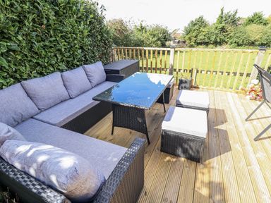 An outdoor seating area with a sofa and table at Church View in Withernwick near Aldbrough