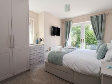 A bedroom with a bed and television at Church View in Withernwick near Aldbrough