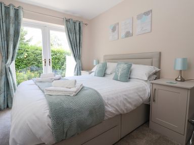 A bedroom with a double bed and bedside tables at Church View in Withernwick near Aldbrough