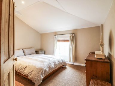 A bedroom with a bed and side table at 5 Prospect Place Woodbridge