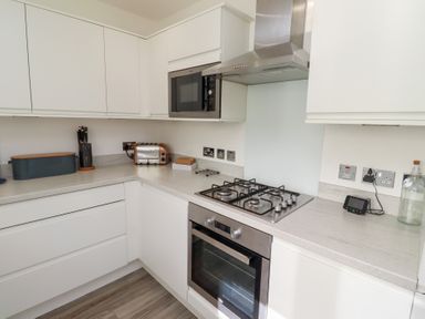 A kitchen with appliances and counters at The Beach House (Beadnell)