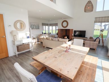 A living room with a table and chairs at The Beach House (Beadnell)