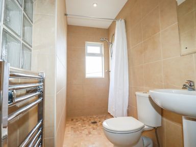 A bathroom with a toilet sink shower and heated towel rail at Brookfield in St Gennys near Wainhouse Corner