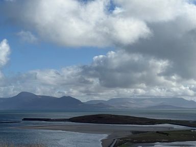 A view of an island surrounded by water and mountains at Geesala