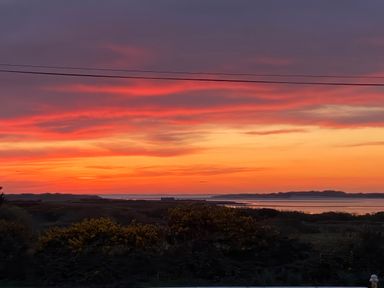 A sunset over water and land at Geesala in Gweesalia