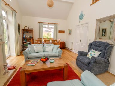 A living room with a sofa and coffee table at 1 Fernhill Avenue, Weymouth