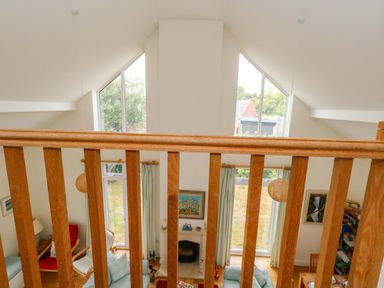 A living room with a balcony view at 1 Fernhill Avenue in Weymouth