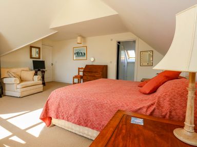A bedroom with a bed and a desk at 1 Fernhill Avenue in Weymouth