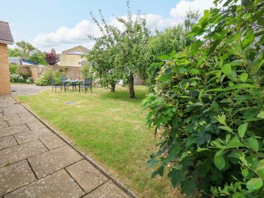 A garden with a table and chairs at 1 Fernhill Avenue Weymouth