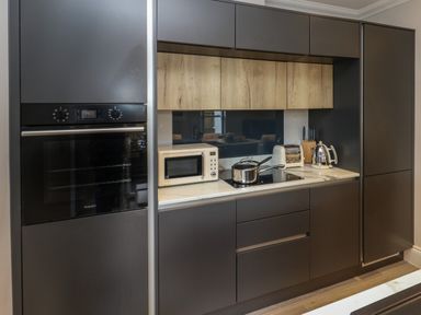 A kitchen with built in oven microwave stovetop toaster kettle and cabinets at 3 Compass Point in Weymouth