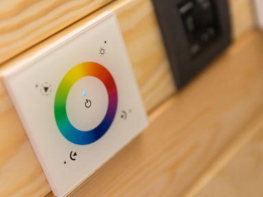 A wall mounted color wheel light switch controller on a wooden wall at Sun Rise in St Buryan