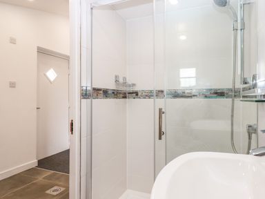 A bathroom with a glass shower enclosure a showerhead and a sink at Strawberry Bank - Kingfisher in Pyworthy near Bridgerule