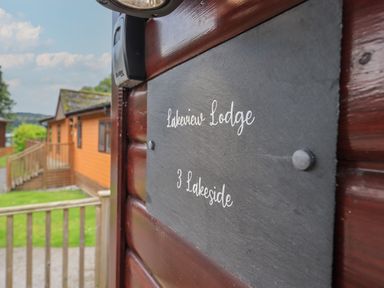 A wooden lodge with a black sign reading Lakeview Lodge 3 Lakeside at Lake View Lodge in Lakeside 3 White Cross Bay Windermere