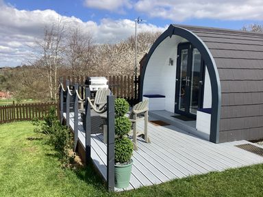 A cabin with a deck and barbecue at Cherry Pod 2 Hookagate near Meole Brace