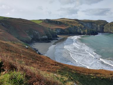 A coastal landscape with cliffs beaches and waves at The Mill in Trethevy near Tintagel
