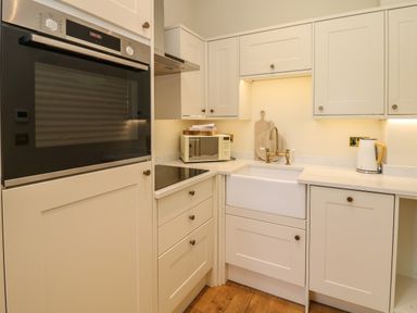 A kitchen with an oven microwave sink and kettle at The Pavillion in Kirklinton near Longtown