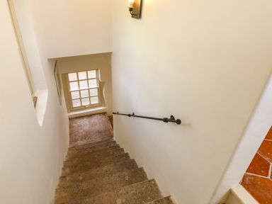 A staircase with stone steps and a window at the bottom at The Pavillion in Kirklinton near Longtown