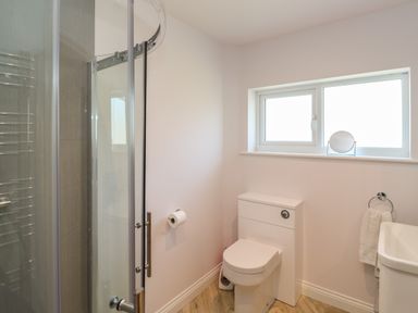 A bathroom with a toilet sink shower and towel at Greenside Studio in Praa Sands