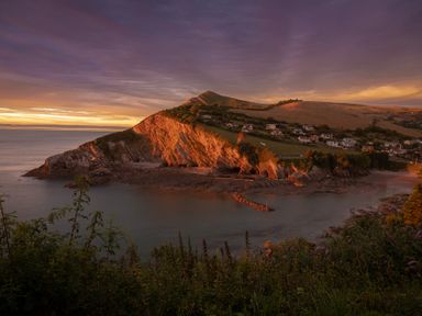 A coastal view with cliffs and houses at 9 Manleigh Park, Combe Martin