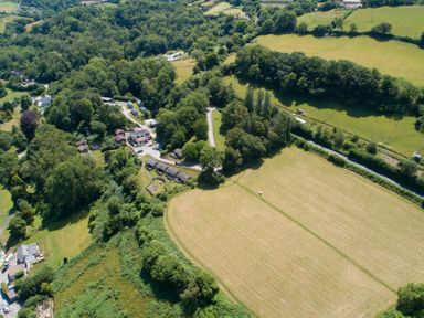 An aerial view of a landscape with houses and fields at 9 Manleigh Park in Combe Martin