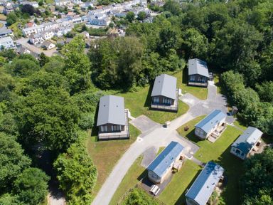 An outdoor area with multiple houses and a pathway at 9 Manleigh Park in Combe Martin