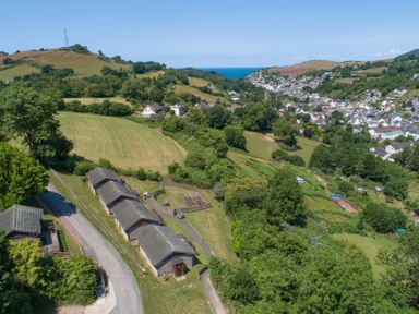 A view of houses and fields near the coast at 9 Manleigh Park in Combe Martin
