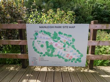 A site map of Manleigh Park showing chalets bungalows lodges and caravans with pathways and green areas