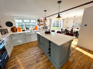 A kitchen with an island, dining table, and chairs at Old Post Office in Sherborne