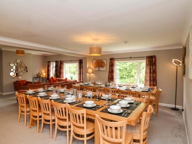 A dining room with a large table and chairs at Hazelgarth House Hunmanby