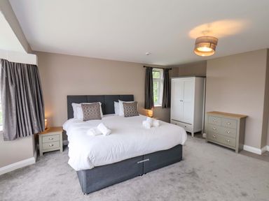 A bedroom with a bed and furniture at Hazelgarth House in Hunmanby