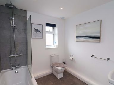 A bathroom with shower and bathtub at Hazelgarth House in Hunmanby