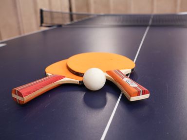 Ping pong paddles and a ball on a table at Hazelgarth House in Hunmanby