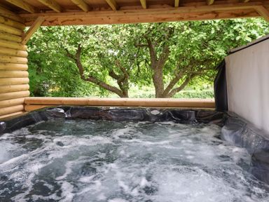A hot tub surrounded by trees at Hazelgarth House in Hunmanby