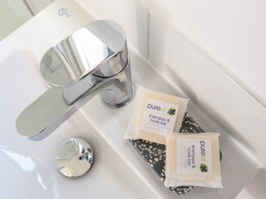 A bathroom sink with a silver faucet and two shampoo and body bars on a soap dish at Little Pip in Gulval
