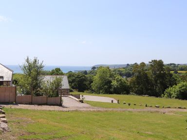 A landscape with grass, trees, houses, and a view of the sea at Little Pip in Gulval
