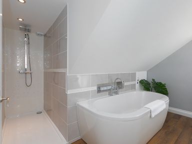 A bathroom with a freestanding bathtub and a walk in shower at Spernenwyn in St Ives