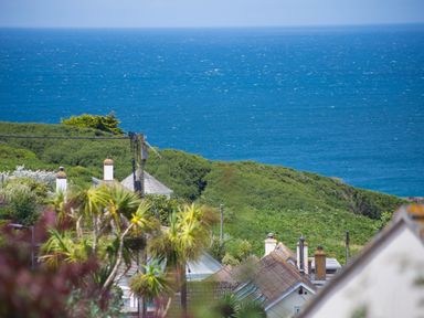 A coastal view with houses and greenery overlooking the sea at Spernenwyn in St Ives