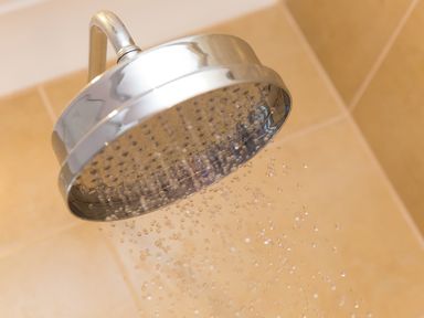 A close up of a metal shower head with water droplets coming out at Spernenwyn in St Ives