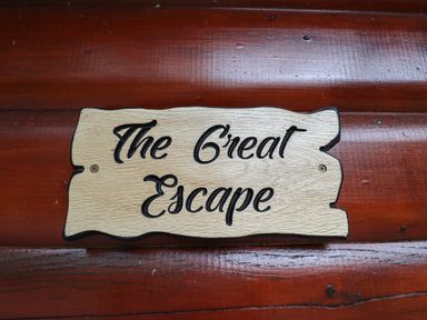 A wooden sign with the text The Great Escape on a wooden wall at The Great Escape in Kenwick near Louth