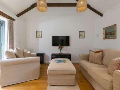 A living room with sofas and a coffee table at Carines Barns - Tre in Cubert