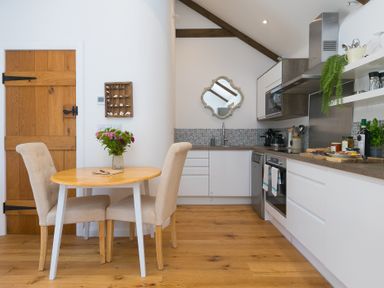 A kitchen with a table and chairs at Carines Barns - Tre in Cubert