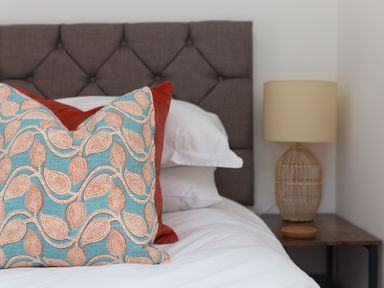A bedroom with a pillow and lamp at Carines Barns - Pen, Cubert