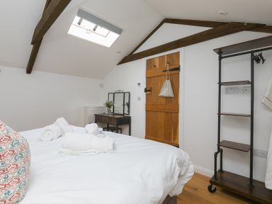 A bedroom with a bed and a dresser at Carines Barns - Pen, Cubert