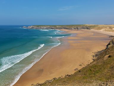 A beach with ocean waves and sand at Carines Barns - Wesley Barn in Cubert