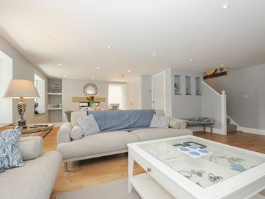 A living room with a sofa table and lamp at Cob Cottage near Rock