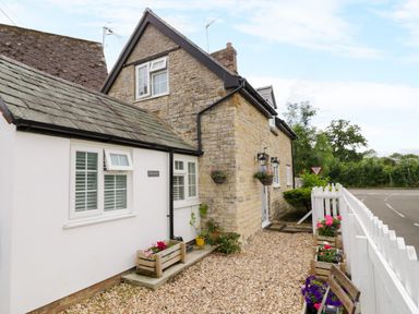 An exterior view of a cottage with garden features at The Cottage in Ettington