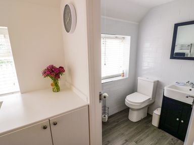 A bathroom with a toilet and a sink at The Cottage in Ettington