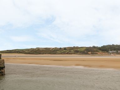 A river with a sandbank and hills in the background at Henwood Barn in Henwood near Upton Cross