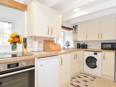 A kitchen with appliances and a flower vase at Henwood Barn near Upton Cross