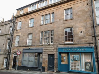 A street view of a building with two storefronts including penn gallery and multiple windows Upper Oakwood Alnwick